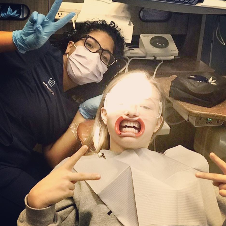 A happy patient with a restored smile after a comfortable session at Elite Dental Center in Wheaton, MD. 